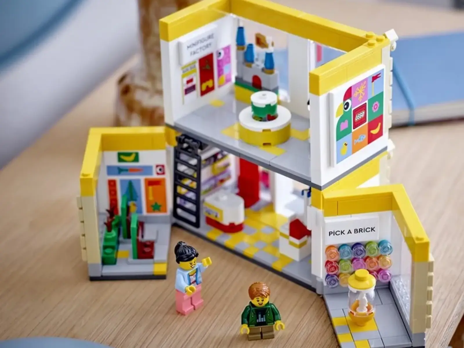 Conjunto de uma loja LEGO em miniatura, com bonecos e prateleiras, ilustrando a variedade de produtos com desconto.